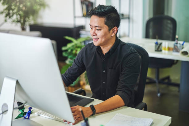 istock Shot of a young businessman working at his desk and using his computer 1352461061
