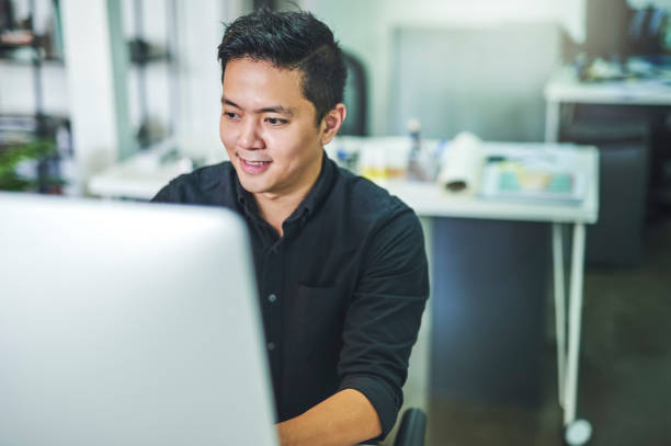 istock Shot of a young businessman working at his desk and using his computer 1352461062