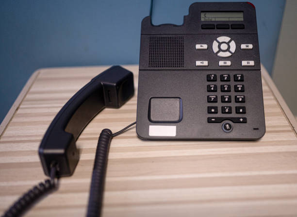 istock corded black office desk phone 1352462205