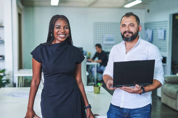 istock Shot of two businesspeople together while using a laptop 1352462215