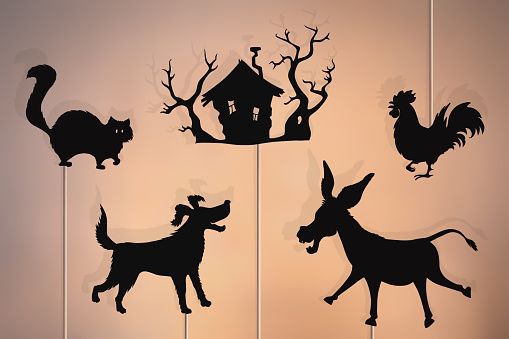 Shadow puppets of donkey, rooster, dog, cat and forest hut. Bremen town musicians storytelling.