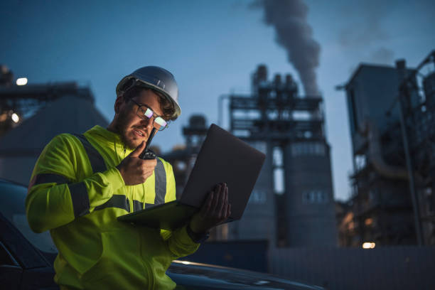 istock Engineer report a problem during night shift in gas and oil industry 1352464954