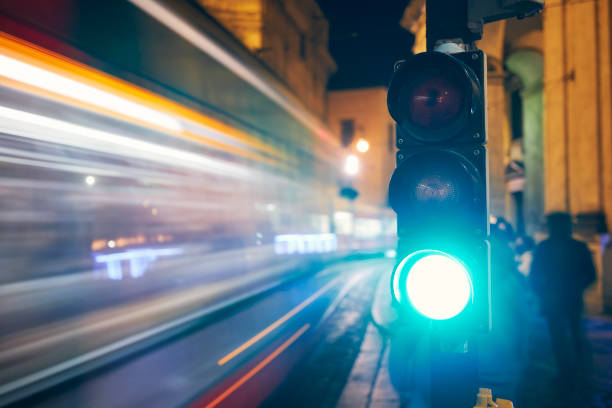 istock Green on traffic light against light trails of tram 1352465957