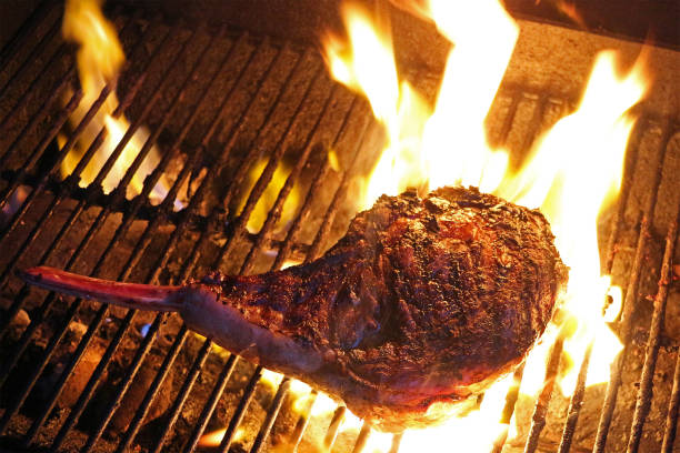 istock Tomahawk Ribeye flames searing on grill 1352466050