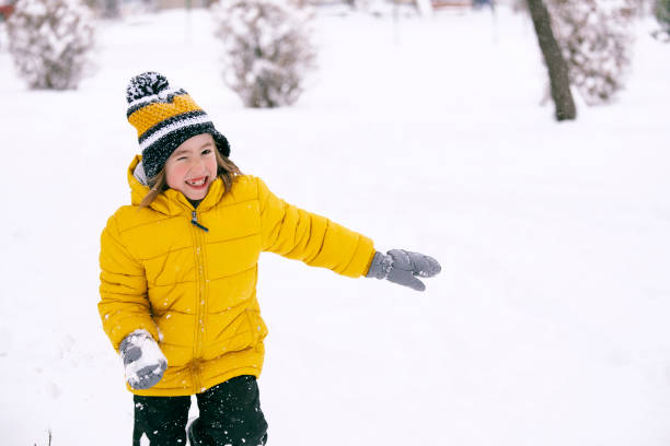 istock Cute kid enjoying the first snow in winter 1352466128