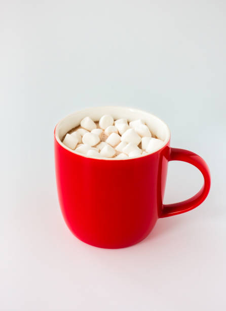 istock Red Mug filled with Hot Chocolate and Mini Marshmallows isolated on White 1352467585