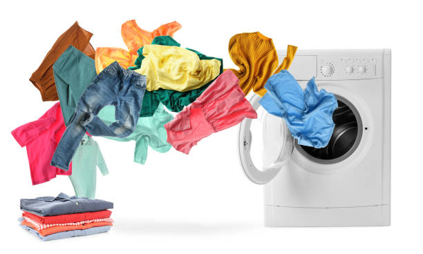 istock Washing machine and flying clothes on white background 1352469994