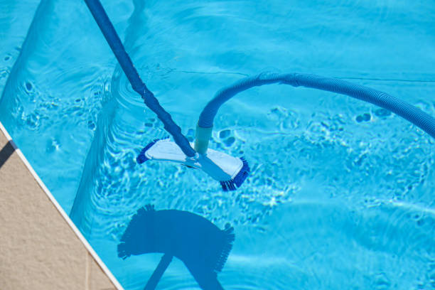 istock Cleaning outdoor pool with underwater vacuum, closeup 1352470700