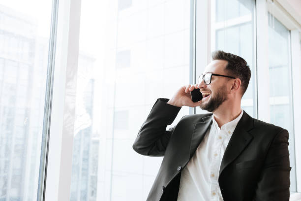 istock Happy Bearded business man talking on phone and looking away 1352470761