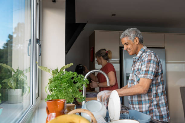 istock Couple Washing Dishes Together 1352475116