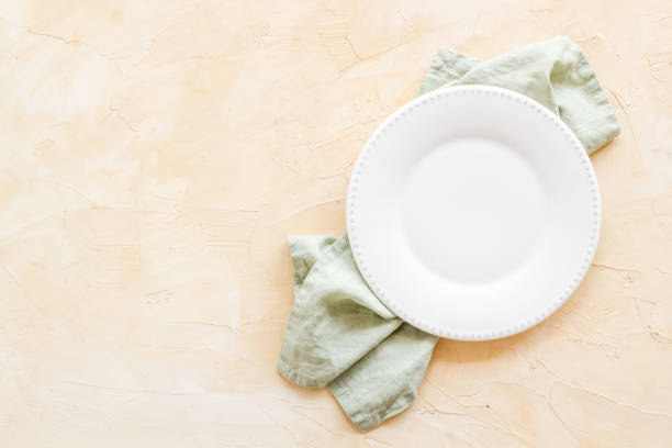 istock Top view of empty plate on napkin. Table setting for dinner 1352475225
