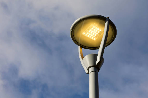 istock Glowing led lamp against the blue sky with white clouds 1352476145