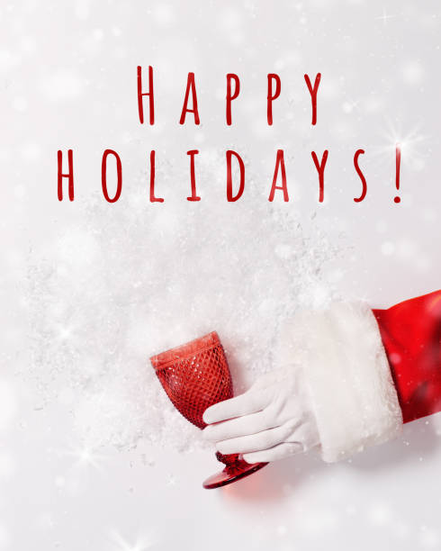 Santa hand hold glass from red glass from which snow scattered, creative concept of winter holidays, New year, Christmas party. Red glassware for festive drink Santa hand hold glass from red glass from which snow scattered, creative concept of winter holidays, New year, Christmas party. Red glassware for festive drink, wine, alcohol, text happy holidays faity stock pictures, royalty-free photos & images