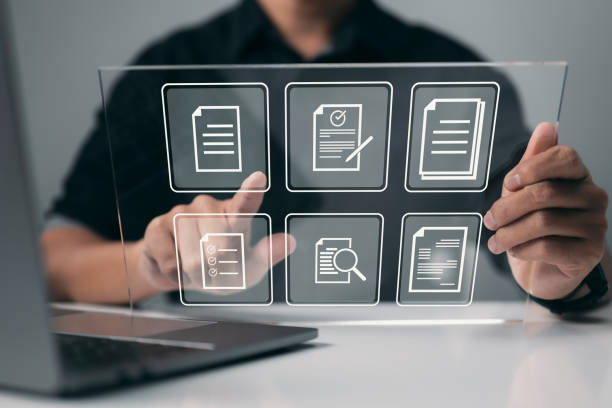 istock Businessman works on a virtual screen. To manage files more efficiently, automate processes. Concept of an online documentation database and document management system. 1352476329