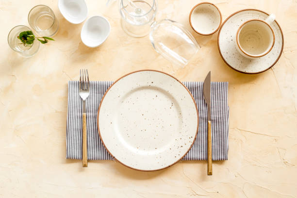 istock Crockery set - table setting for dinner with dishes and glasses 1352476468