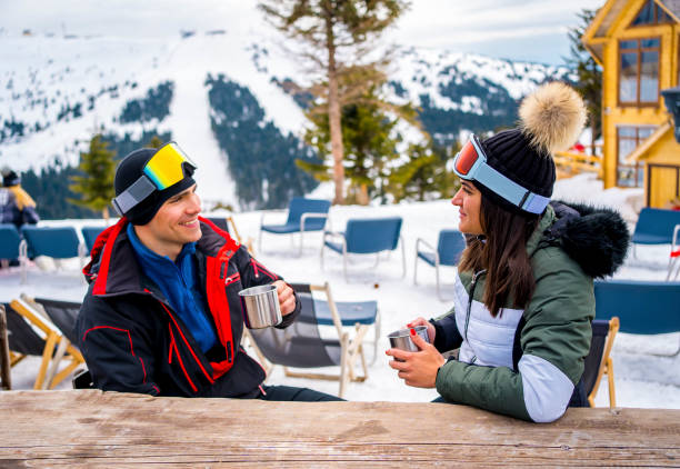 istock Couple enjoying in a hot drink at ski cafe 1352478843
