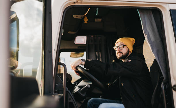 Portrait of young Caucasian bearded truck driver stock photo