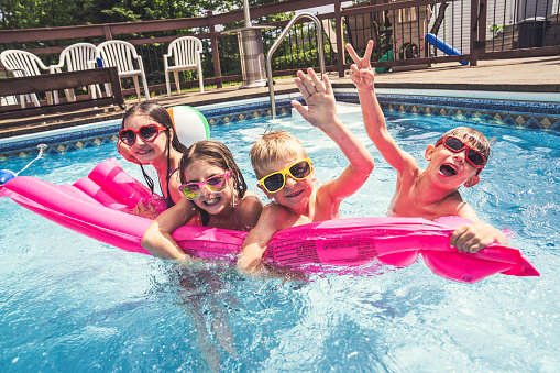 A group of children having fun in Pool on the summer time