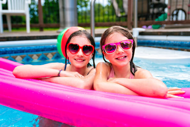 istock two sister having fun in Pool on the summer time 1352481510
