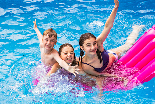 A group of children having fun in Pool on the summer time