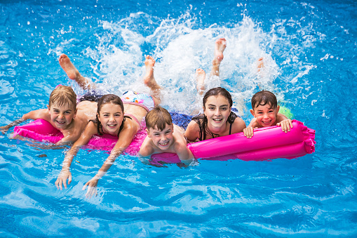 A group of children having fun in Pool on the summer time