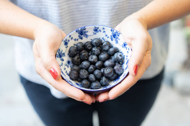 istock holding a bowl of blueberries 1352482417