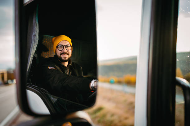 The truck driver uses the phone stock photo