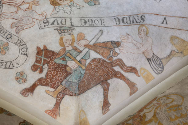 Martin of Tours cutting his cloak in two and gives one half to a begger, an anciet fresco in Skibby church stock photo
