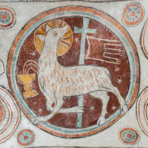 Lamb of God with a cross and ensign,  bleeding into the Holy Chalice, an ancient mural in Skibby church Lamb of God with a cross and ensign,  bleeding into the Holy Chalice, an ancient mural in Skibby church, Denmark, June 28, 2021 agnus dei stock pictures, royalty-free photos & images