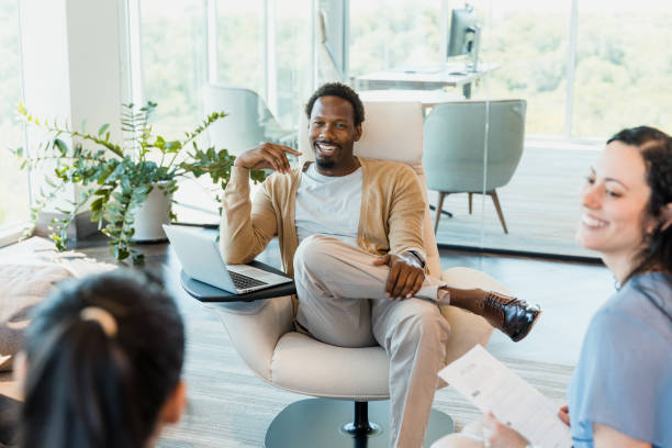 istock Male team lead smiles at unrecognizable female co-worker 1352488508