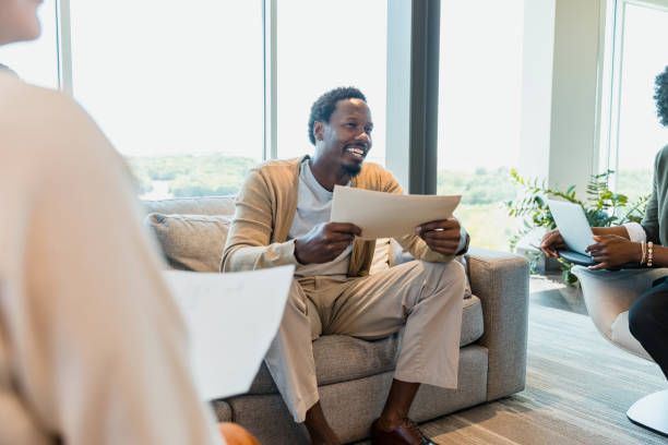 istock Mid adult man smiles while presenting numbers from his department 1352488526