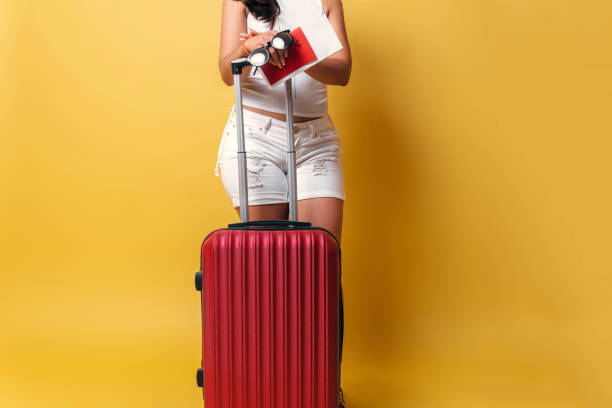 istock Unrecognizable woman holding a suitcase travel. 1352489826