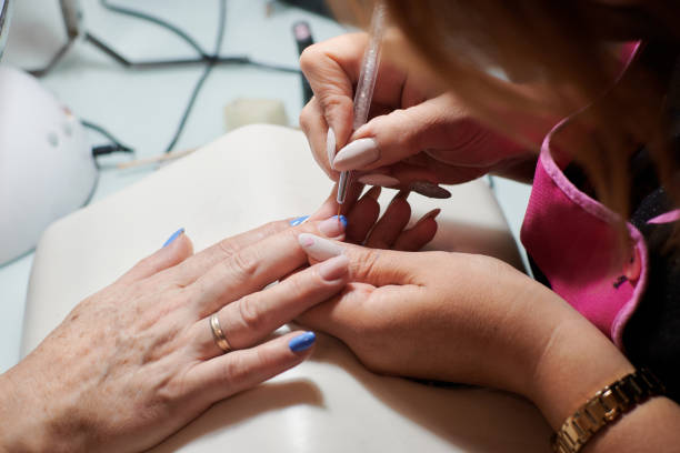 istock Professional manicurist fixes and beautifies a client's nails 1352489880