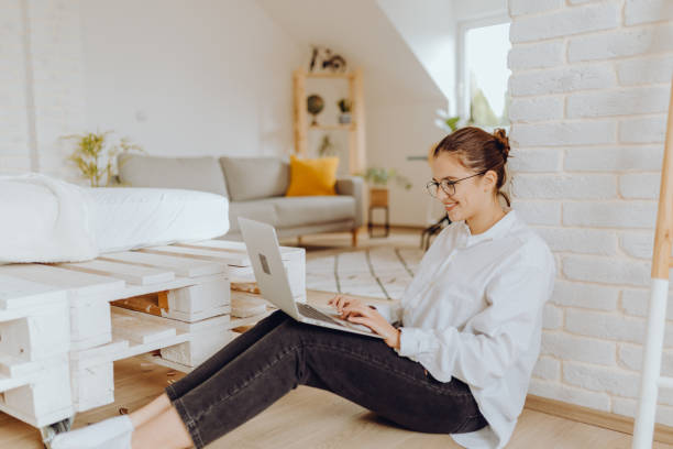 istock Happy young Woman in her Home Office and Using her Laptop 1352492137