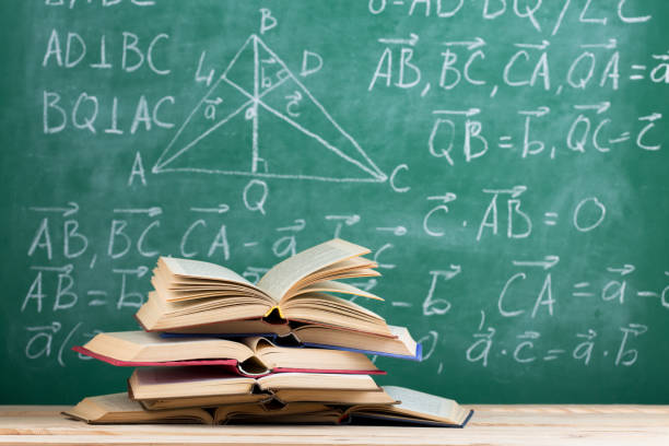 istock Education concept - books on the desk in the auditorium 1352493390