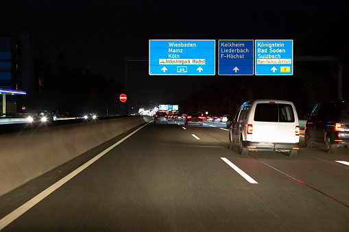 Road signs on German highway A66 nearby Frankfurt at night. Bundesautobahn A66 (abbreviated BAB 66 or A66) is a heavily frequented highway in the Southwest of Germany. It connects the cities of Wiesbaden, Frankfurt and Fulda. Some road users in the background.