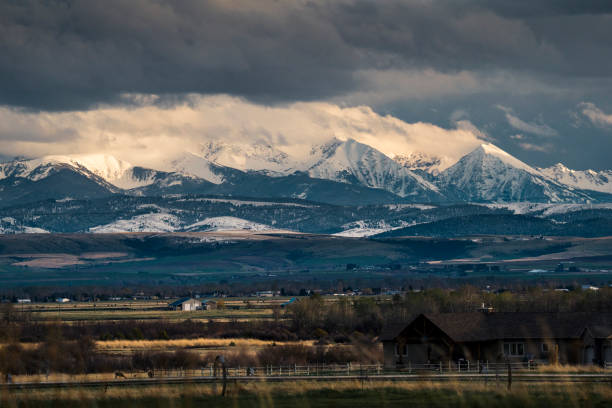 Fall comes early to the high country of Montana. While the plains are still baking in the heat of summer, the Continental Divide is taking on the hues of autumn. This scene of the Rocky Mountain Front Range was photographed from the Pine Butte Guest Ranch near Choteau, Montana, USA.