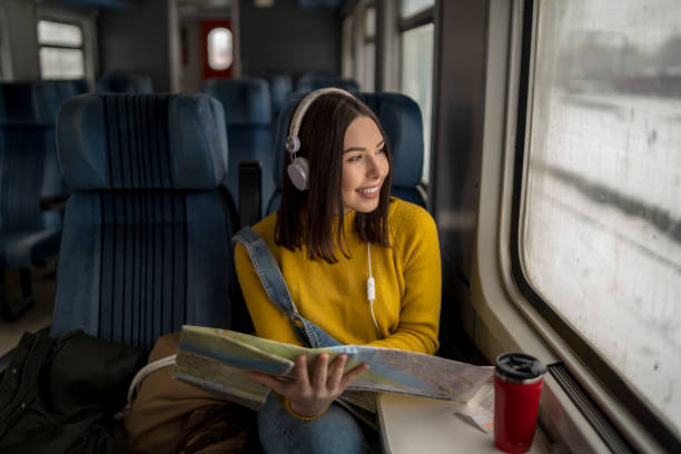 istock Young woman in train is reading a map 1352495324