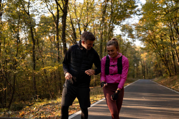 istock Couple running i the forest on the road 1352495487