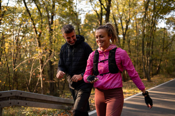 istock Couple running i the forest on the road 1352495515