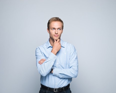 right side face of an asian man with inquisitive expression looking towards a copy space with white background