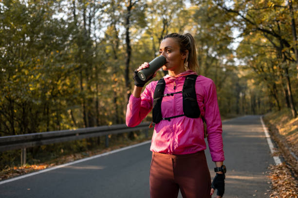 istock Woman drinking water during training activities 1352495659