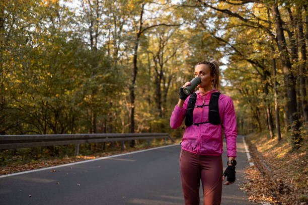 istock Woman drinking water during training activities 1352495752