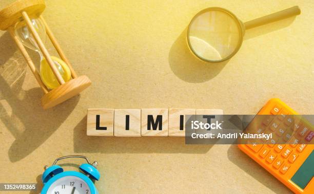 Wooden Blocks With The Word Limit Hourglass Magnifying Glass Risk Management In The Banking And Financial Sector Business And Finance Concept Quantitative Limitation Maximum Range Stock Photo - Download Image Now