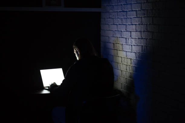 istock Back view image of young concentrated man using laptop 1352499480
