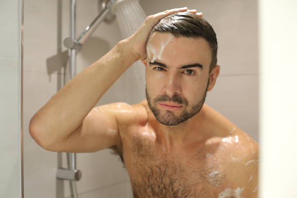istock Young man in the shower 1352500421