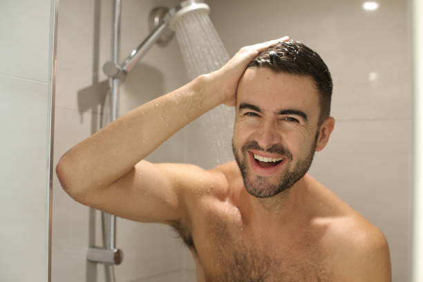 istock Handsome man smiling in the shower 1352500453