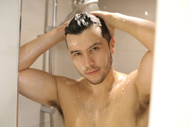 istock Young man in the shower 1352500465