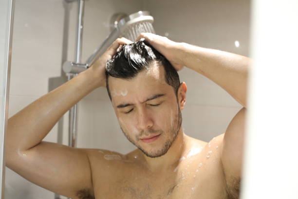 istock Young man in the shower 1352500694