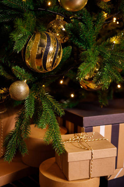 istock christmas gift in cardboard box near new year tree 1352501421